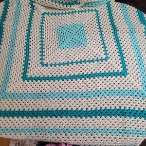 Handmade crochet afghan 58 x 58. It is cream color with shades of teal/green